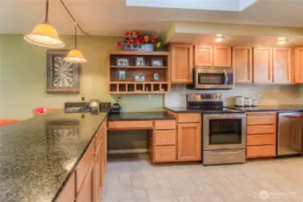 Spacious kitchen with hard surface counter tops and eating bar