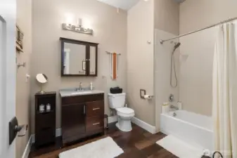 Enjoy plenty of space in this Airbnb full bathroom with high ceilings and a bathtub with shower surround. Matching medicine cabinet mirrors echo the primary suite’s modern look, and the tankless water heater guarantees nonstop hot water throughout the entire home.