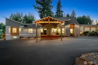Rain or shine, the huge covered drive-thru awning has your back, making unloading groceries or guests a breeze without ever getting wet. The contemporary exterior pairs sleek lines with warm wood accents for a look that’s both modern and inviting. Plus, the expansive driveway offers easy turnaround space, so arriving and leaving feel effortless, even on busy days.