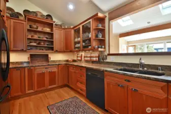 Well appointed kitchen features custom cabinets, a large walk in pantry, and under cabinet lighting.