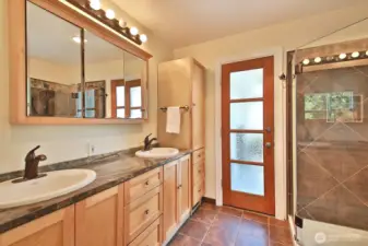 Heated floors are such a joy in the primary bath. Beautiful marble countertops add to the warmth. If you love the heat, hit the hot tub through the glass doors.