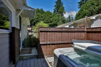 The hot tub off the Primary Bath has a privacy fence for those who bath in the buff.