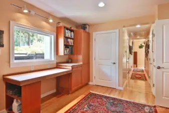 A large Laundry/Mud/Office area provides plenty of room for hobbies and crafts of all kinds. The white countertop opens up to twice its size for a large sewing/crafts table.