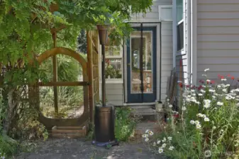 Side gate to backyard and entrance to the attached greenhouse room.