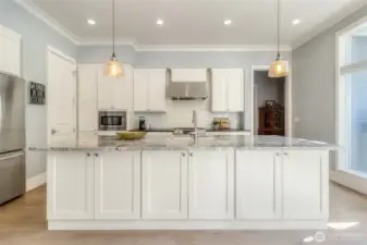 Granite countertops, walk-in Pantry and stainless steel appliances in this open kitchen