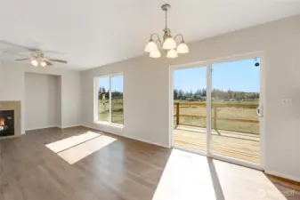 The open family room to dining area and kitchen offers abundance of natural light and natural scenery.