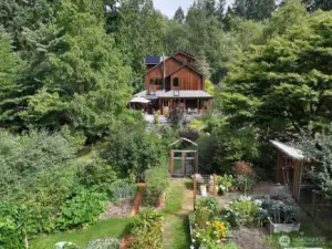 Classic Northwest Maxwelton Valley home on a sunny perch surrounded by forested acreage with gardens and a trail to miles of public trails on The Chinook lands of The Whidbey Institute and the Whidbey Island Waldorf School.