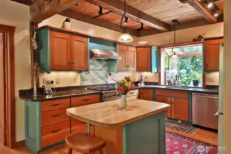 Updated kitchen (2012) with custom fir cabinets and a propane range/stove. A garden window at your kitchen sink. Door to the Family Room and main level Full Bath is along the left edge of this photo.