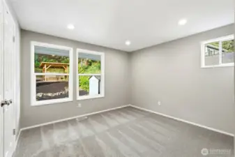 Bedroom 2 with Large Windows and Peaceful Backyard Views
