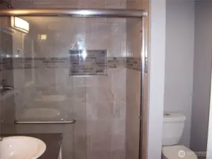 Large shower with plenty of room, with glass doors