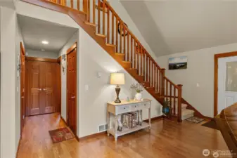 The door under the stairs leads down to the lower level/garage