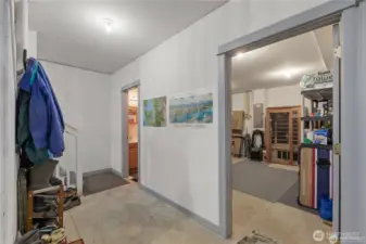 Coming down the stairs leads to a 1/2 bath and a massive storage room - next to the tandem garage showroom