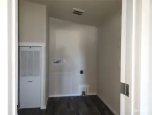 Laundry room with extra storage space off kitchen.