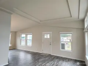 Back wall of living room looking to front door. Love the coved ceilings.