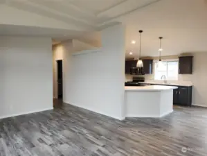 Living room with view to hallway and kitchen.