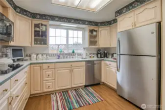 Amazing Kitchen with large amount of cupboards, counters space, Drawers, and large refrigerator.