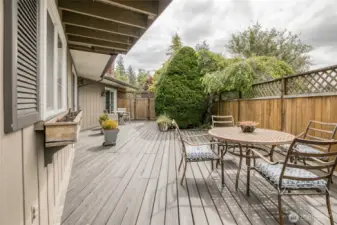 Private wooden deck with eating area.