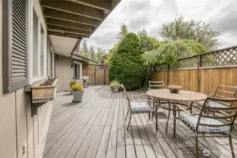 Private wooden deck with eating area.