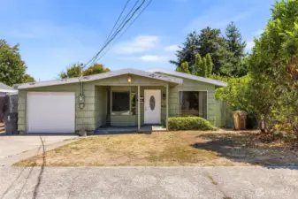 One story home on a large lot has over 1200sf, three bedrooms, one and a half baths, living and family rooms, and an attached garage plus ample additional parking