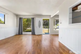 Looking back to the front door and front window - true hardwood flooring
