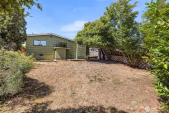 Generous back yard is fully fenced.  The two windows you see are both to bedrooms.