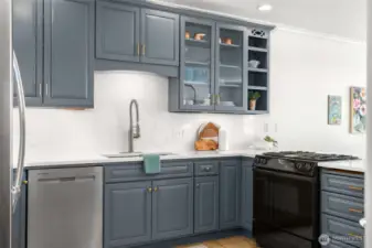 Undermount sink, undercabinet lighting, display shelf, lazy susan, slab quartz backsplash
