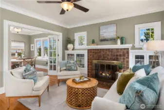 The living room opens seamlessly to the dining area, highlighted by French doors and abundant natural light, perfect for entertaining.