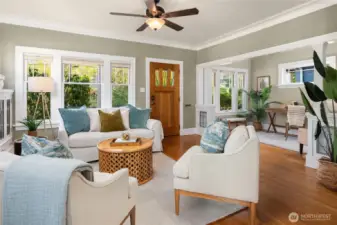 An open, flowing layout connects the living room to the front entry and flexible office nook.