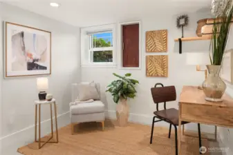 A versatile bonus room doubles as a private home office or creative studio, complete with cozy textures and natural light.