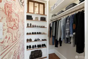 Spacious walk-in closet featuring charming, vintage-inspired touches.