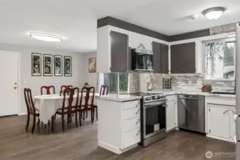 Partial view of kitchen and the family room. Seller currently uses FR as a dining area.