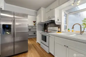 Open pantry shelves out the back of the kitchen leading to the 4th bedroom and laundry room and back entrance.