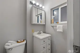 1/2 bath off the open pantry area at the back of the kitchen