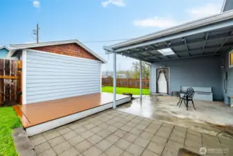 Raised deck. There is a dog run and a garden shed behind the gate on the left.