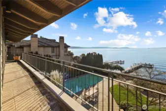 Sophisticated indoor–outdoor living defines the home, with multiple decks and patios flowing seamlessly to resort-style grounds.