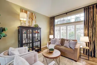 High ceilings with tall windows finished with glossy white shutters add to the ambiance of this home.