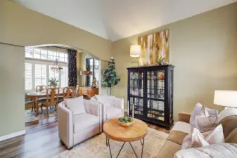 The living room transitions to the dining room, awashed in natural light.