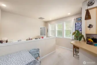 Looking back toward the entry stairs.  Primary bedroom in the background, kitchen to the right.