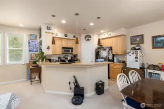 Efficient kitchen with eating space and dining area.