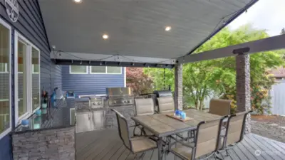 As if the deck wasn't impressive enough as it is, it also features a stunning built-in outdoor kitchen with grill and mini fridge.