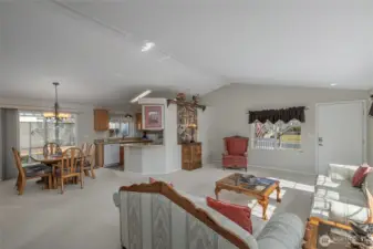 open living, dining and kitchen area with slider to covered patio