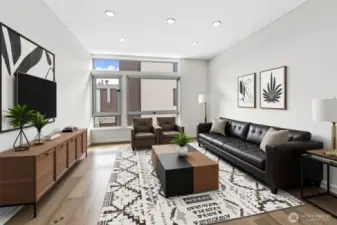 Note virtually staged living room. Boasts high ceilings and walls of windows.