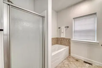 Tub and shower in the primary bath.