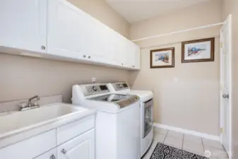 Utility Room with newer washer, dryer, and closet.