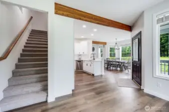 Kitchen and stairwell to 3/4 bath and three sleeping rooms.