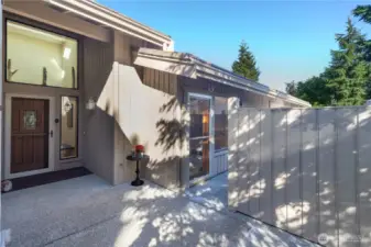 View of the front door, and access to the private, gated courtyard that has access to the guest bedroom that doubles as a den or craft room.