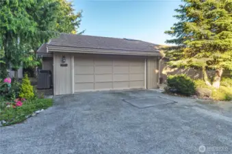 This privately located condo has an oversized, two car garage. Note the heat pump on the left-hand side. This efficient heating and cooling system is well maintained and energy efficient.