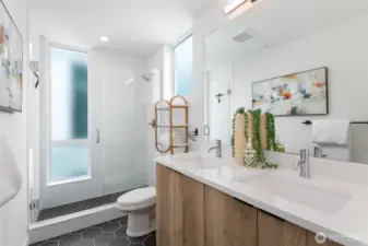 Luxurious primary en-suite bathroom with double sinks.
