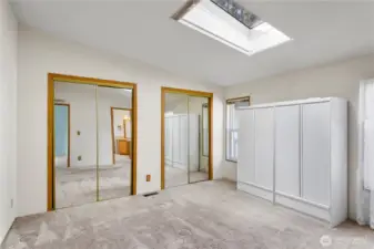 Primary suiet has mirrored closet doors, and looks out to the masive driveway.  The skylight has a shade to close for the day sleepers.