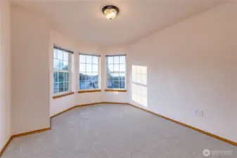The bay windows in a primary bedroom suite